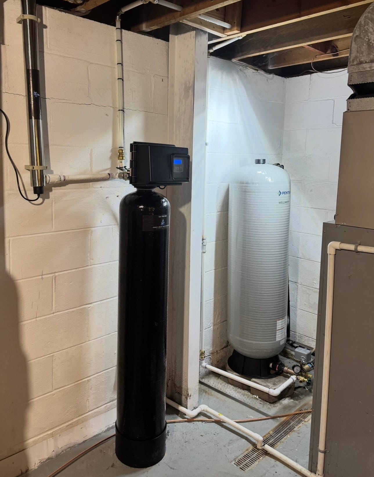 Cesare's hydrogen sulfide treatment installation with treatment tank and UV light in Southwestern PA home